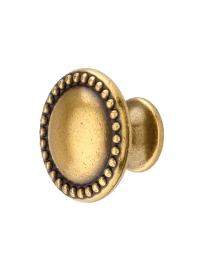 Beaded Round Cabinet Knob in Antique Brass Light.